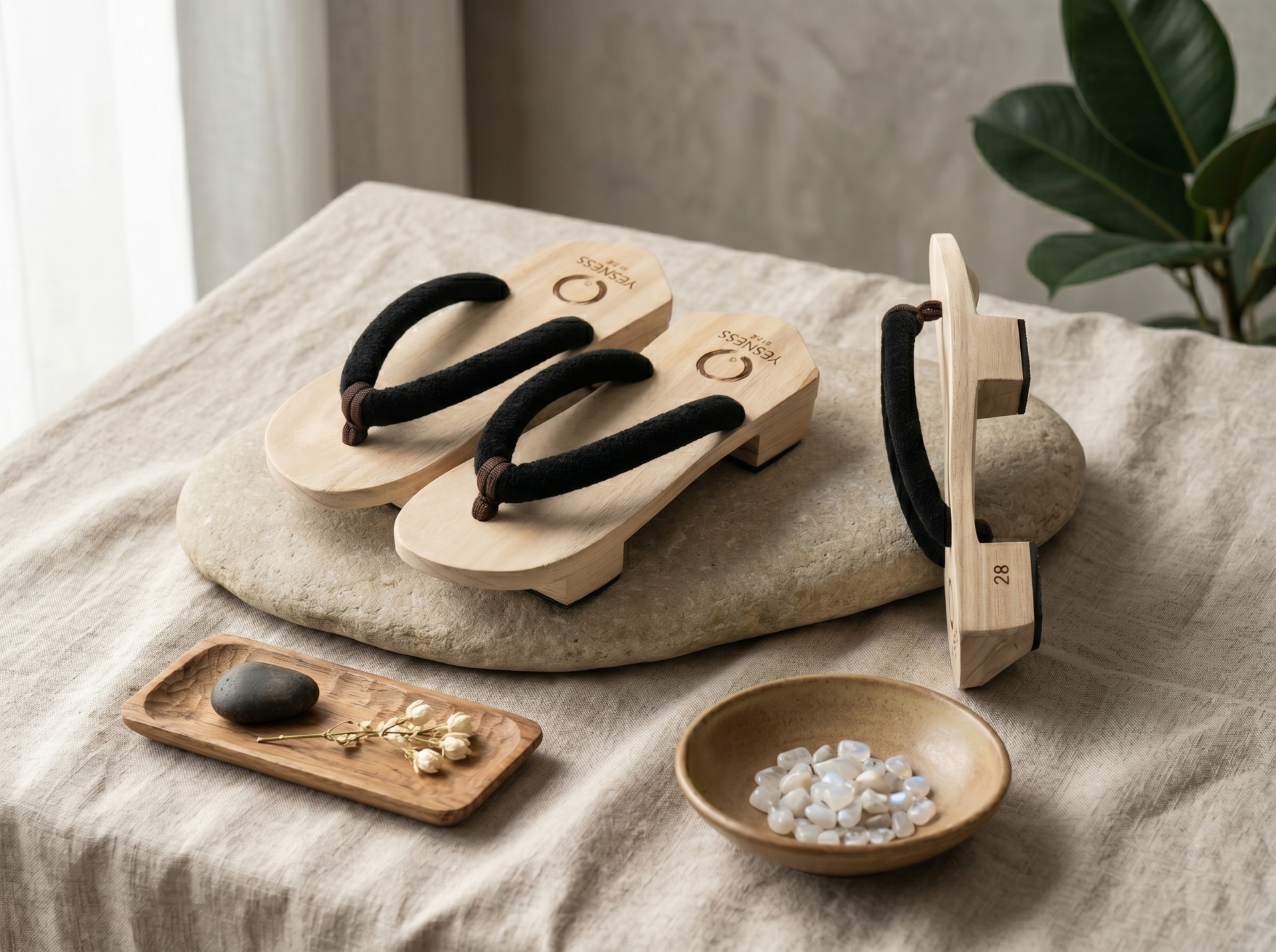 YESNESS geta on a stone slab with linen, dried flowers and moonstone — ritual still life